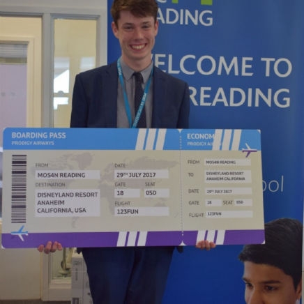 Jonathan holding an enlarged plane ticket, from the MOS competition. 